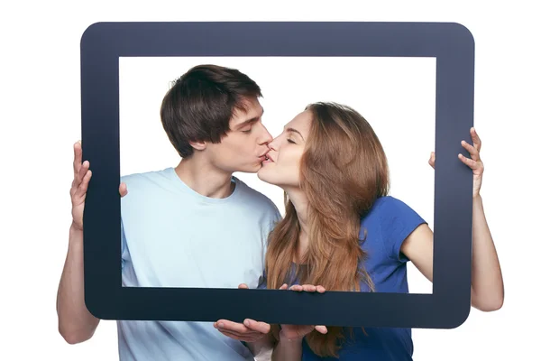 En el amor pareja celebración tableta marco besos —  Fotos de Stock