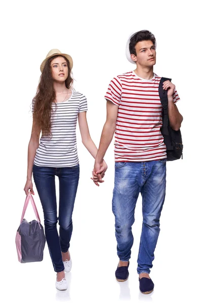 Pareja joven caminando con bolsas de viaje — Foto de Stock