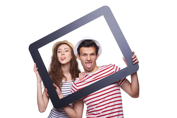 Pasangan bahagia yang menunjukkan lidah melalui bingkai tablet — Stok Foto