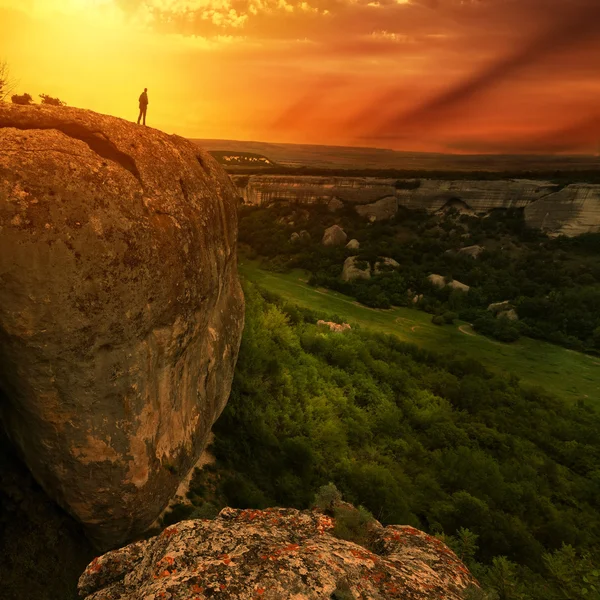 Man silhouette on edge of rock — Stock Photo, Image