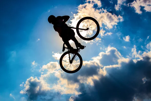 Silhouette of a cyclist on the background of sky