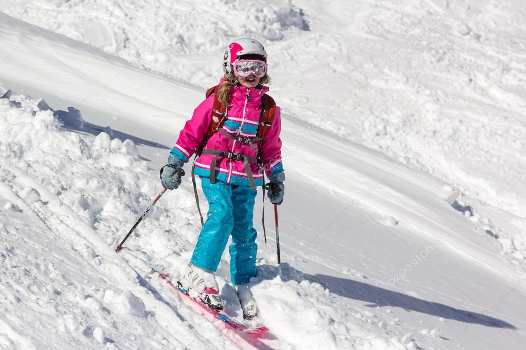 Little girl skier in the deep snow