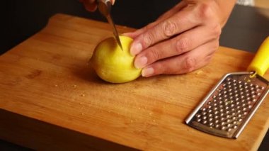 woman hands cutting a lemon close up