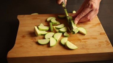 cutting zucchini on wooden chopping board