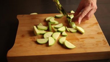 cutting zucchini on wooden chopping board