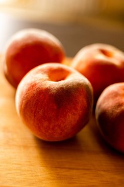 Ripe peaches on wooden board close up