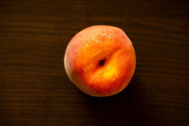 Ripe peaches on wooden board close up