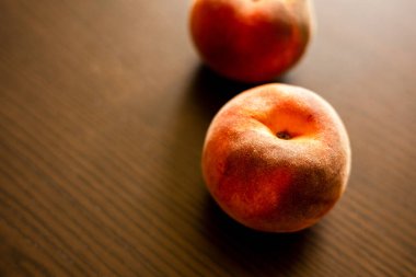 Ripe peaches on wooden board close up
