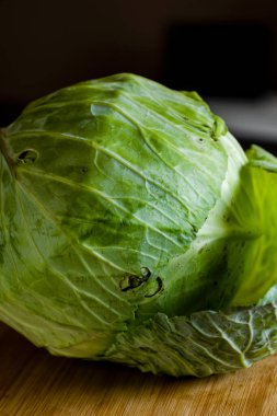 close up raw white cabbage on wooden board