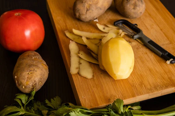 potatoes close up on wooden board at the kitchen table