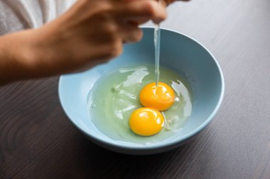 egg yolk in blue bowl close up