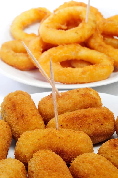 Spanish croquettes and calamares a la romana, breaded and fried — Stock Photo, Image