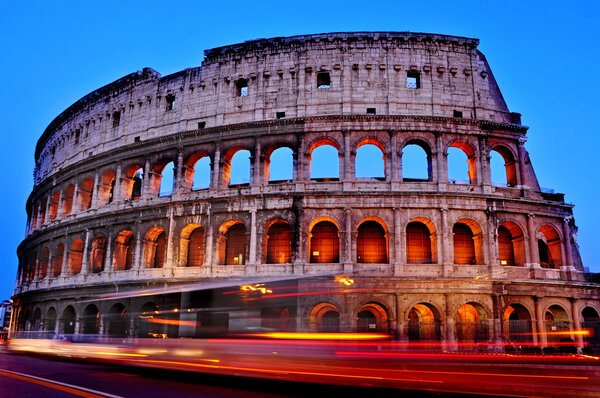 A view of the Flavian Amphitheatre or Coliseum at sunset in Rome, Italy