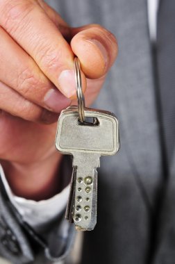 man in suit showing a key ring