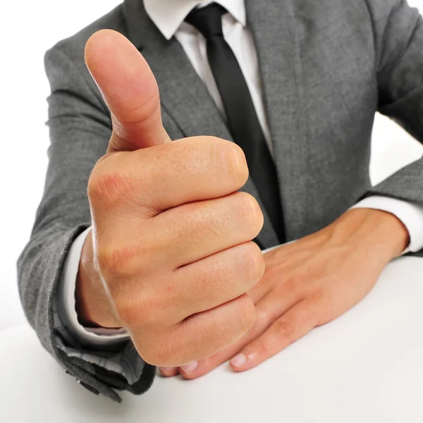 Man in suit giving a thumbs up signal — ストック写真