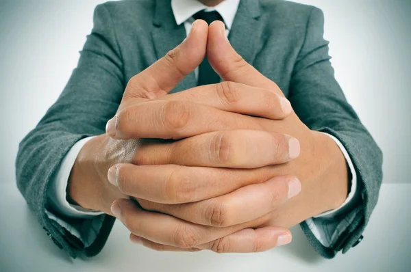 Man in suit with clasped hands — Stock Photo, Image