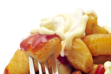 typical spanish patatas bravas, fried potatoes with a hot sauce clipart