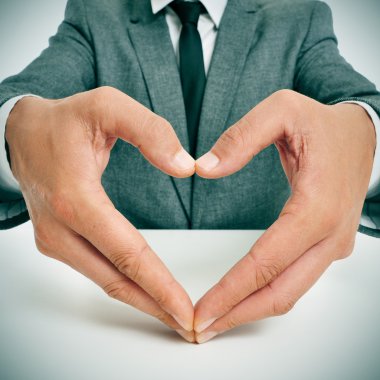 man in suit forming a heart with his hands clipart