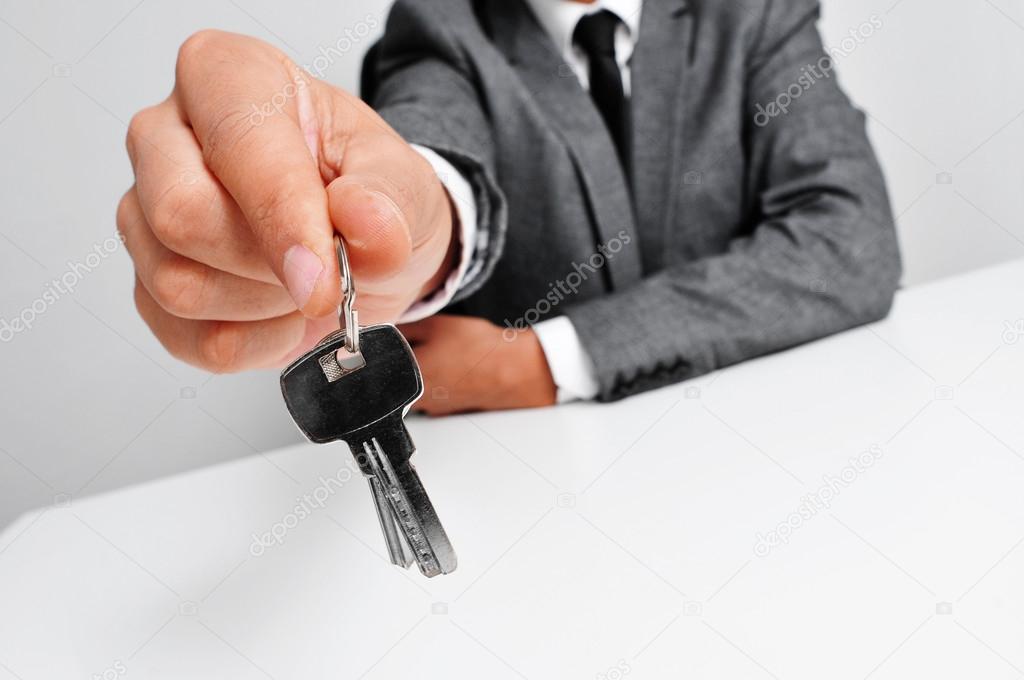 man in suit giving the keys