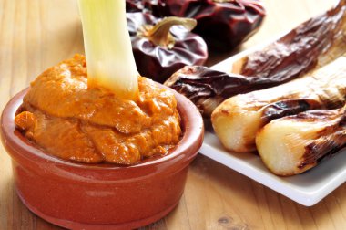 barbecued calcots, sweet onions, and romesco sauce typical of Ca clipart