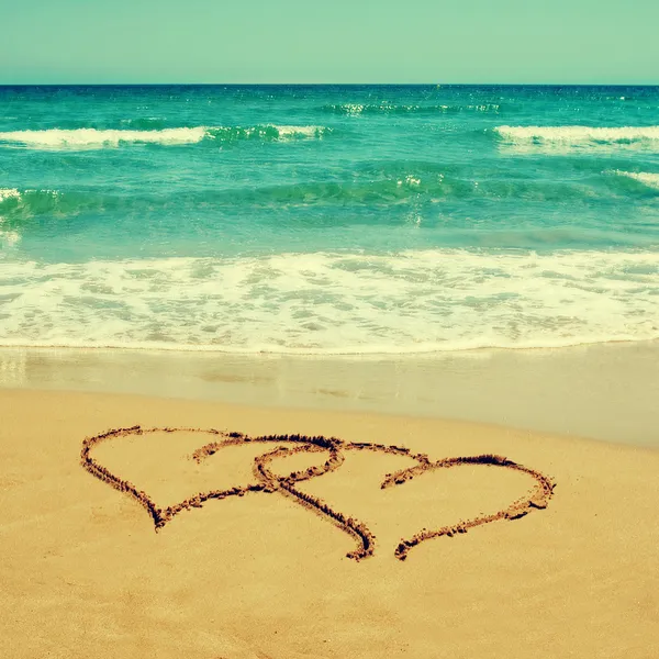 Hearts in the sand of a beach Royalty Free Stock Photos