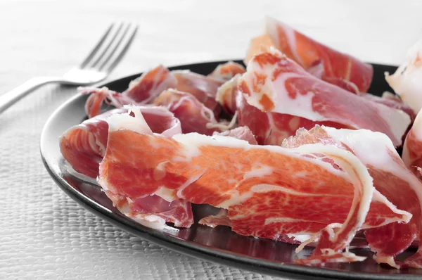 Spanish serrano ham served as tapas — Stock Photo, Image