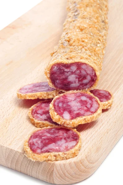 Fuet, a spanish sausage, coated with onion — Stock Photo, Image