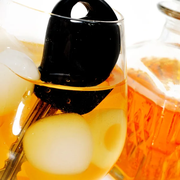 Car key into a glass with liquor, drunk driving — Stock Photo, Image