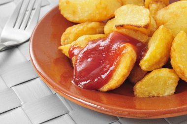 typical spanish patatas bravas, fried potatoes with a hot sauce clipart
