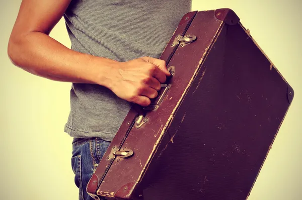 Young man with old suitcase — Stock Photo, Image