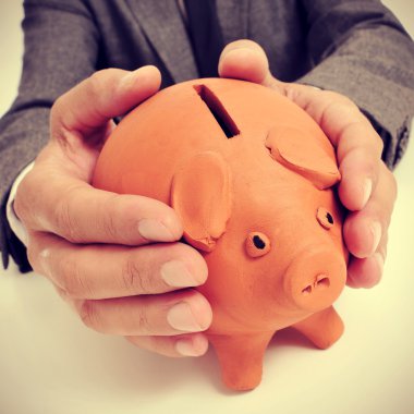 man in suit with a piggy bank clipart