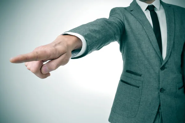 Man in suit pointing with the finger the way out — Stock Photo, Image