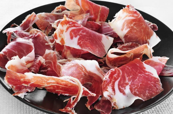 Spanish serrano ham served as tapas — Stock Photo, Image