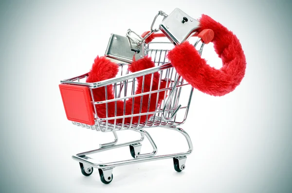 Sexy fluffy handcuffs in a shopping kart — Stock Photo, Image