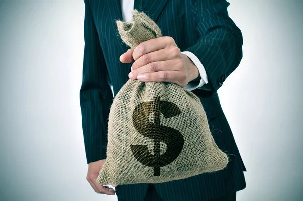 Businessman with a burlap money bag — Stock Photo, Image