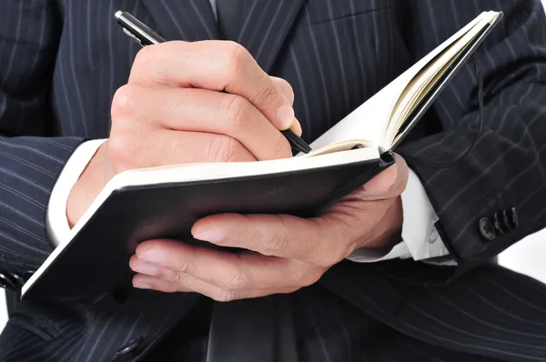 Businessman writing in a notebook — Stock Photo, Image