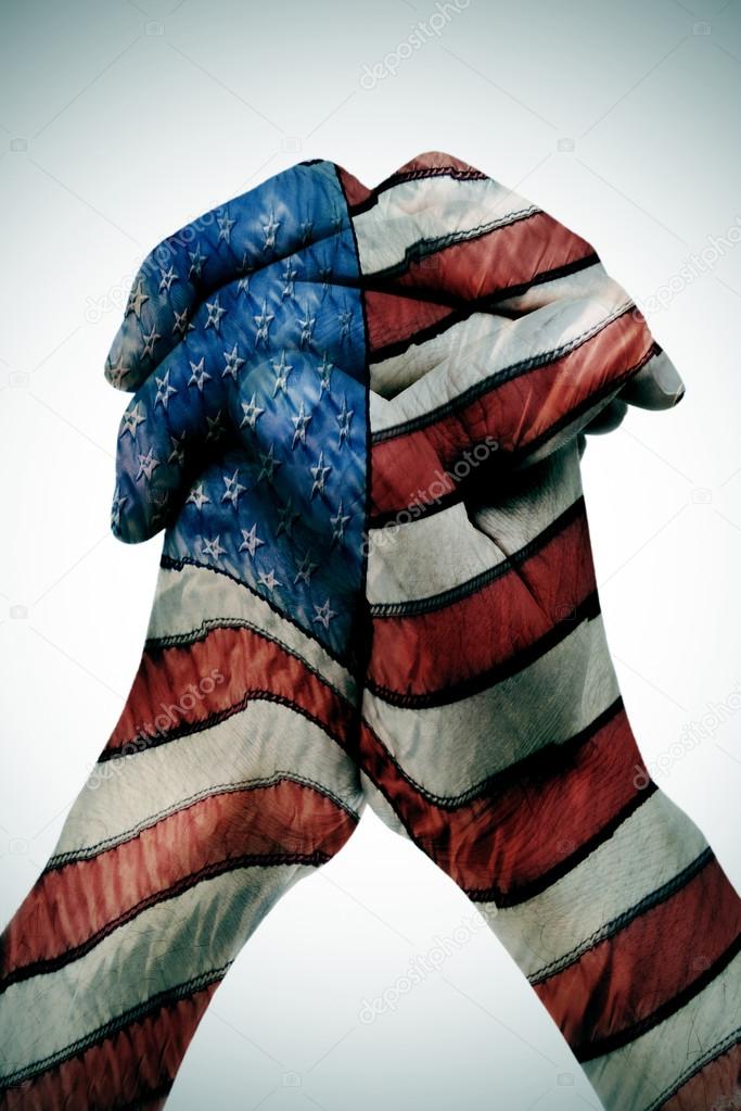 man clasped hands patterned with the american flag