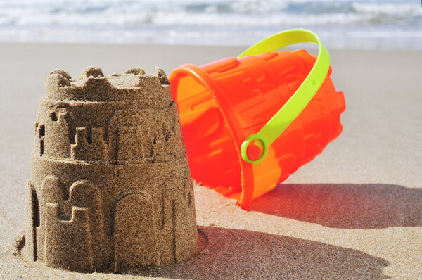 toy bucket sandcastle on the sand of a beach