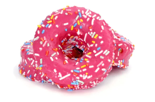 Donuts coated with a pink frosting and sprinkles of different co — Stock Photo, Image