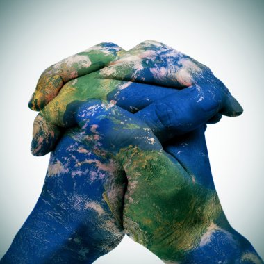 world map in the clasped hands of a man (Earth map furnished by  clipart