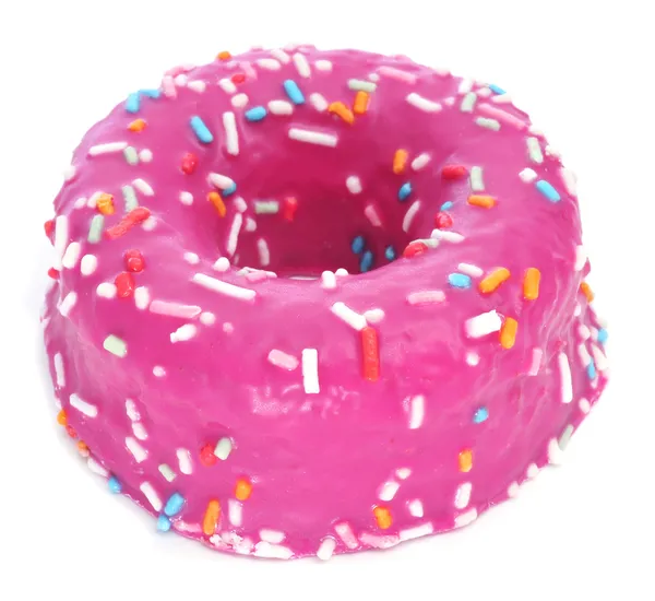 Donut coated with a pink frosting and sprinkles of different col — Stock Photo, Image