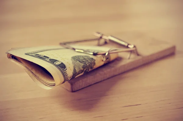 Dollar bills in a mousetrap with a retro effect — Stock Photo, Image