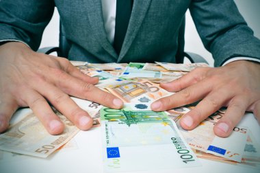 man in suit with euro bills clipart