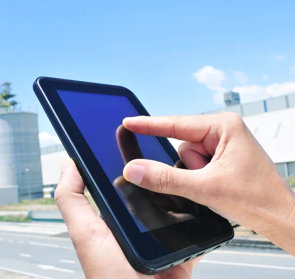 Man using a tablet in an industrial park — Stock Photo, Image