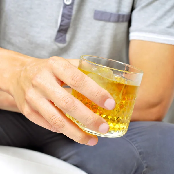 Young man hanging out with a glass of liquor — Stock Photo, Image