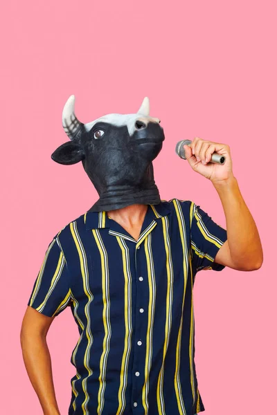 Closeup Young Man Wearing Cow Mask Speaking Microphone Pink Background — Stock Photo, Image