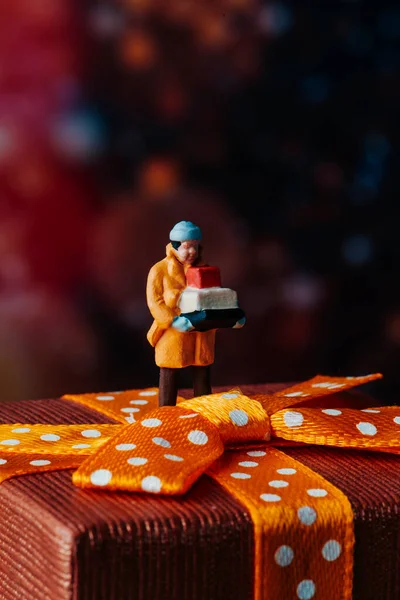Closeup Miniature Man Wearing Coat Carrying Pile Boxes Top Gift — Stock Photo, Image