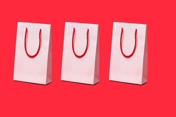 Three White Paper Shopping Bags Red Handles Red Background — Stock Photo, Image