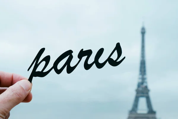 Closeup Hand Young Caucasian Man Holding Silhouette Word Paris Front — Stock Photo, Image