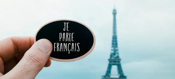 Closeup Man Holding Black Signboard Text Speak French Written French — 图库照片